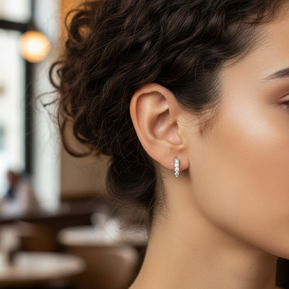 Close-up of a woman's ear with an earring, blurred indoor background