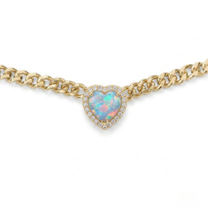 Gold chain necklace with a heart-shaped opal pendant on a white background