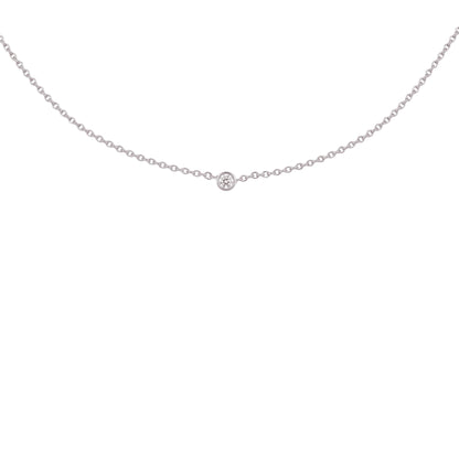 A delicate silver chain necklace with a single small round-cut gemstone at the center, displayed against a solid white background.