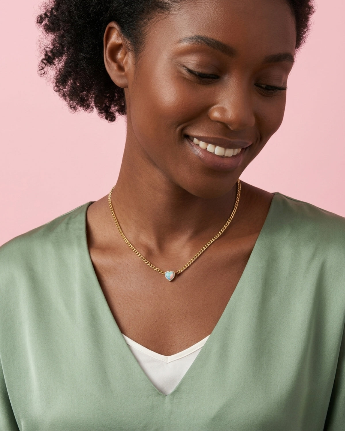 Model wearing waterproof 14k gold jewelry in water, demonstrating non-tarnish 316L steel durability. Opal.