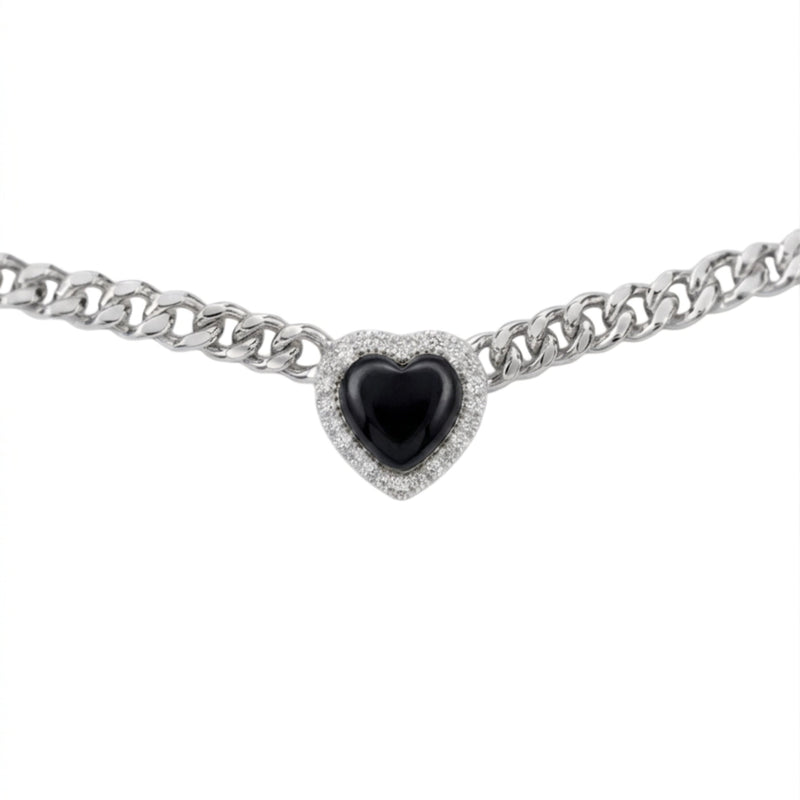 A silver-toned curb chain bracelet featuring a heart-shaped centerpiece with a glossy black center stone surrounded by a halo of small clear stones, shown against a plain white background.
