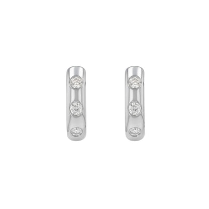 BLOOMTINE Mini Halo Wings silver hoop earrings. These sterling silver earrings are rhodium-plated and feature flush-set moissanite stones. Dainty, hypoallergenic silver earrings perfect for a celestial-inspired ear stack