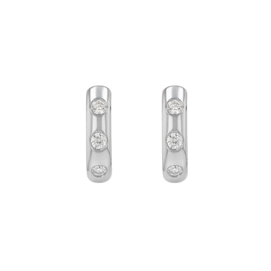BLOOMTINE Mini Halo Wings silver hoop earrings. These sterling silver earrings are rhodium-plated and feature flush-set moissanite stones. Dainty, hypoallergenic silver earrings perfect for a celestial-inspired ear stack