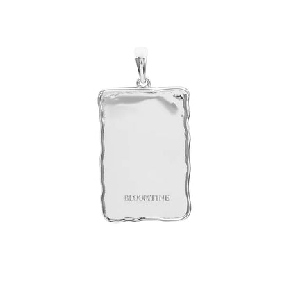 A BLOOMTINE Sterling Silver Angel Wing Pendant, designed as a talisman for protection. This intricately detailed silver wing necklace is shown on a clean white background, highlighting the premium rhodium-plated finish and the symbolic 'Extraordinary Human' craftsmanship