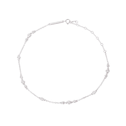 Illuminess-Premium-sterling-silver-sparkle-anklet. A professional-hero-shot of a high-quality-925-sterling-silver-anklet-featuring multiple-shimmering-gemstone designed-to-catch-the-light. The-dainty-silver-chain is displayed-on-a-clean-white-background, showcasing its-brilliant-polished-finish and delicate-craftsmanship. As-the-lead-image for the Illuminess-collection, this-sparkling-anklet represents-the-perfect-summer-accessory or bridal-gift, combining-timeless-elegance with a-modern-shimmering-