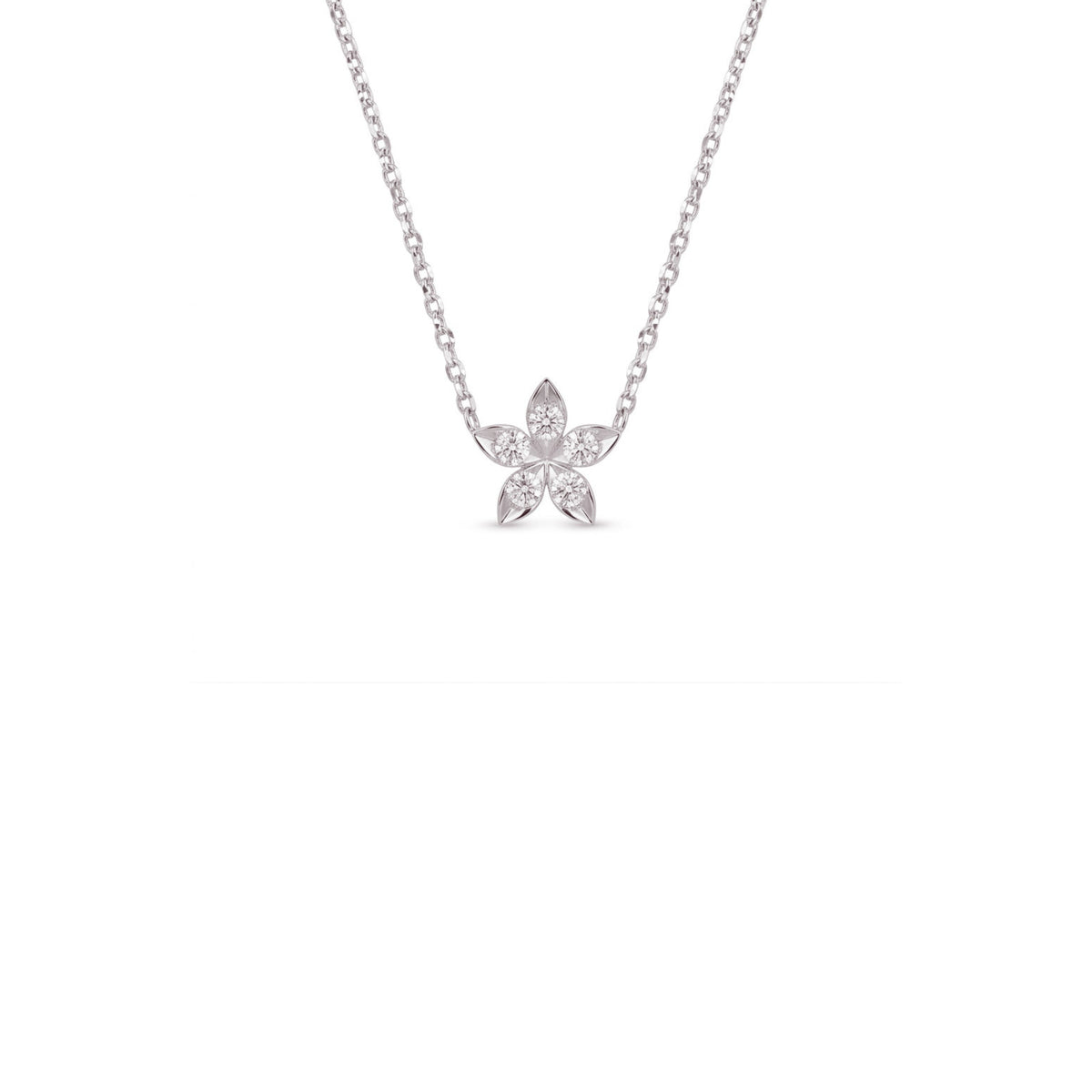 A delicate silver chain necklace with a small flower-shaped pendant set with clear stones, centered against a solid white background.